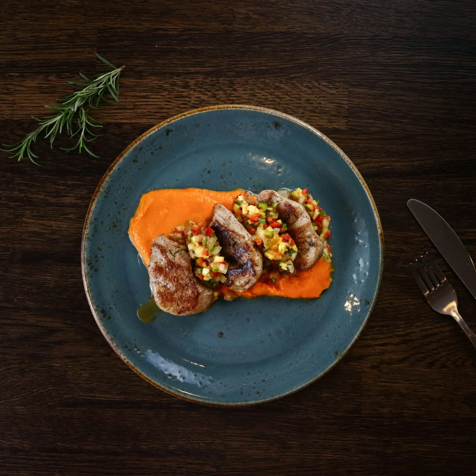 cooked food on blue ceramic plate sous vide Lomo de cerdo a la naranja y romero sous vide: receta perfecta paso a paso